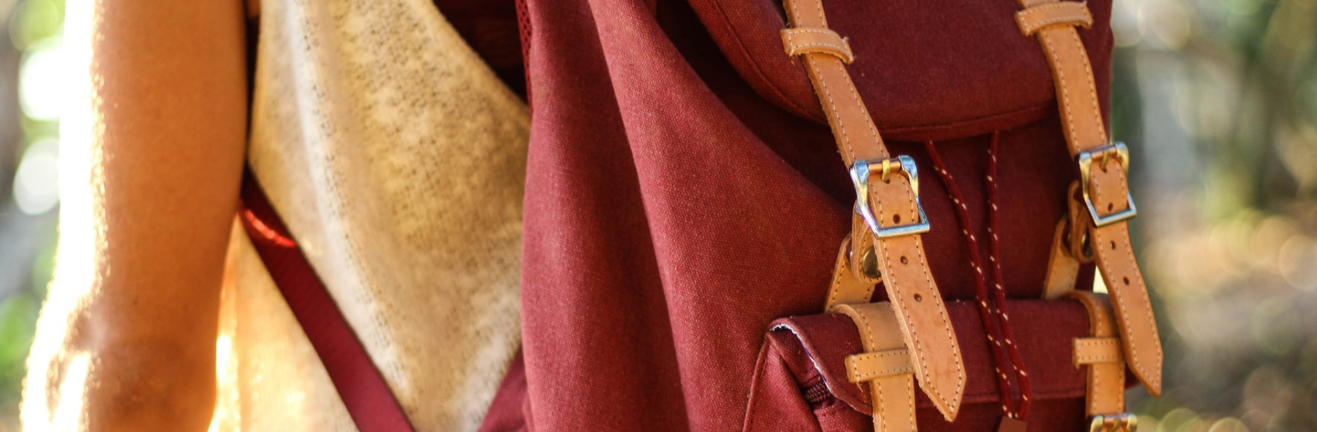 close up of a maroon backpack on a student's back